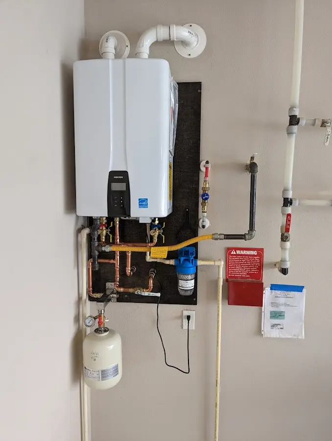 Professional plumber installing copper piping in a Bunker Hill Village home